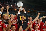 To the victors the spoils ... Injured Lions captain Sam Warburton hold the Tom Richards Cup aloft