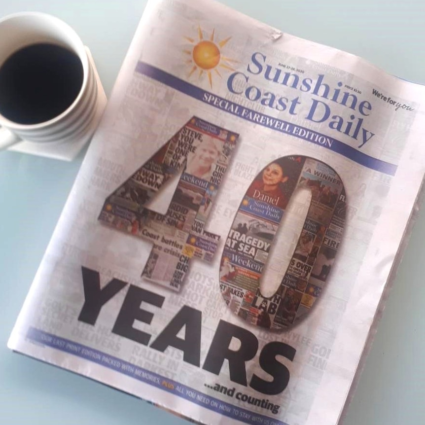 The Sunshine Coast Daily, which says 40 years on its front, with a cup of coffee beside it