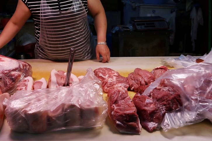 Large pieces of pork on a table ready for sale