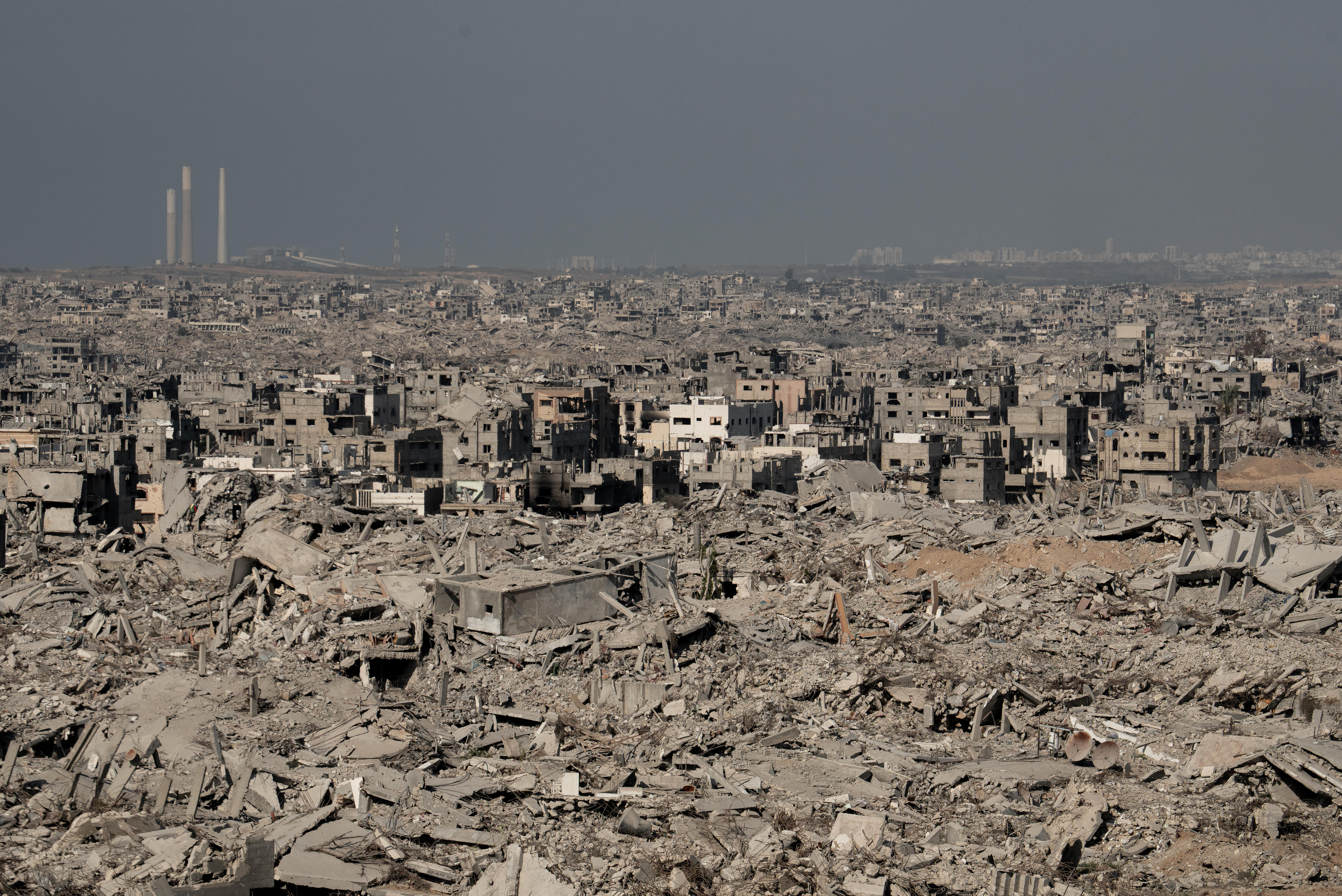 Kilometres of destroyed buildings and rubble. In the distance are three tall circular structures