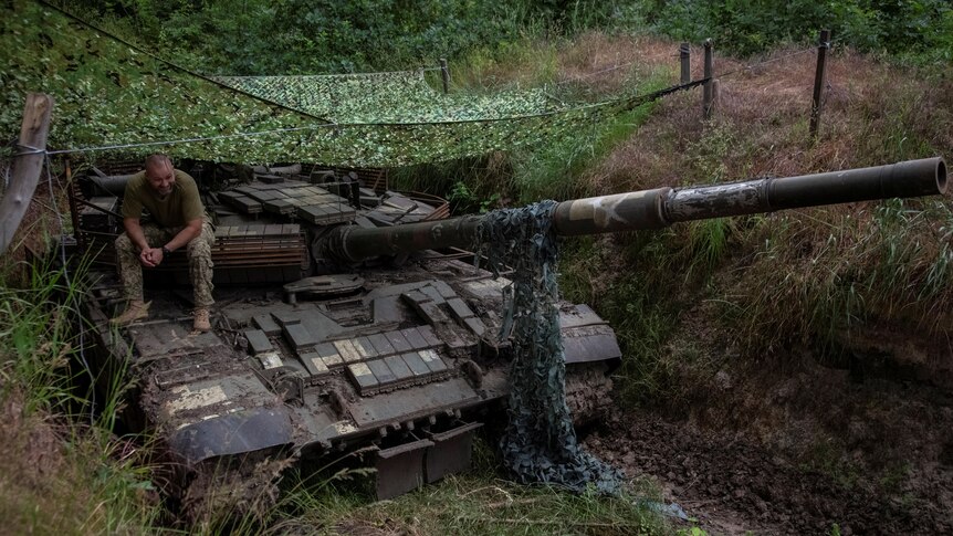  Ukrainian serviceman sits atop a tank, amid Russia's attack on Ukraine, in Donetsk region.