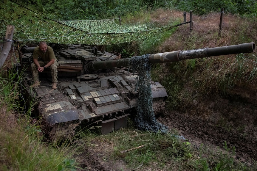  Ukrainian serviceman sits atop a tank, amid Russia's attack on Ukraine, in Donetsk region.