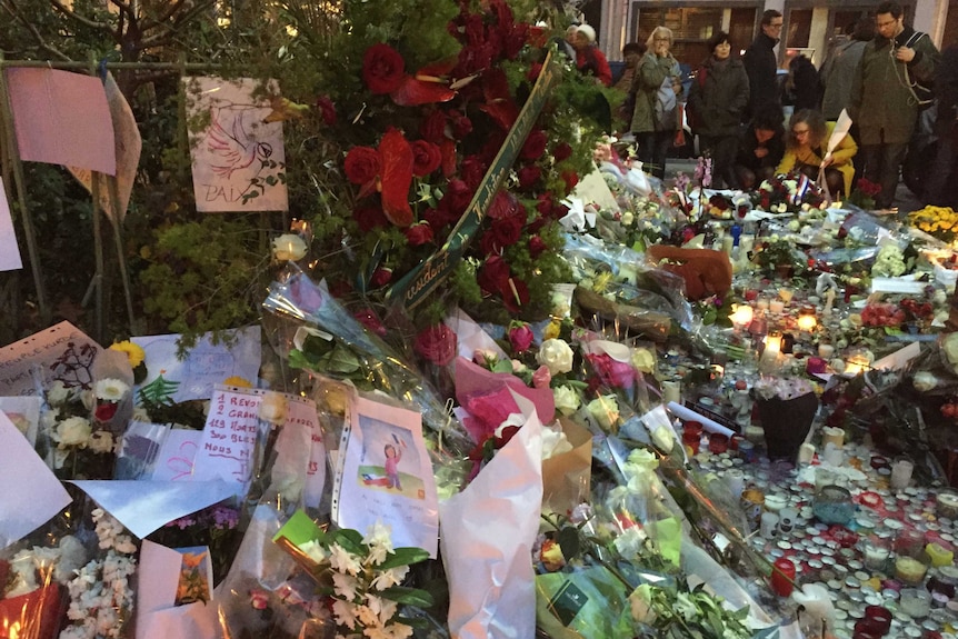 Mourners gather around makeshift memorials in Paris