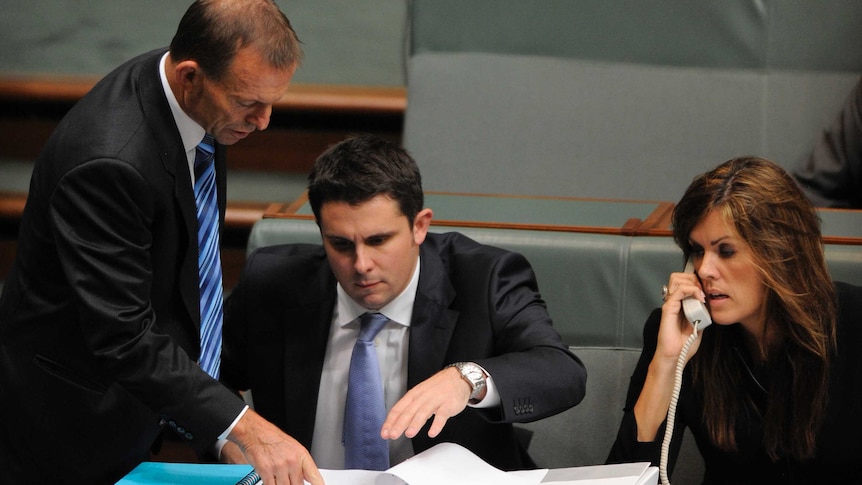 Tony Abbott talks with advisers Andrew Hirst and Peta Credlin
