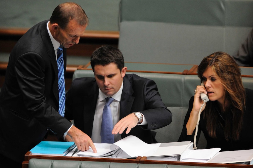 Tony Abbott talks with advisers Andrew Hirst and Peta Credlin