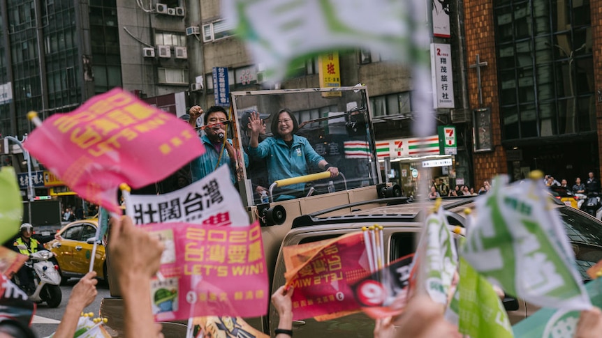 Tsai Ing-wen waves to the crowd from the back of a truck