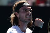 A Greek male tennis player pumps his right fist during Australian Open semifinal.