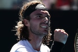 A Greek male tennis player pumps his right fist during Australian Open semifinal.