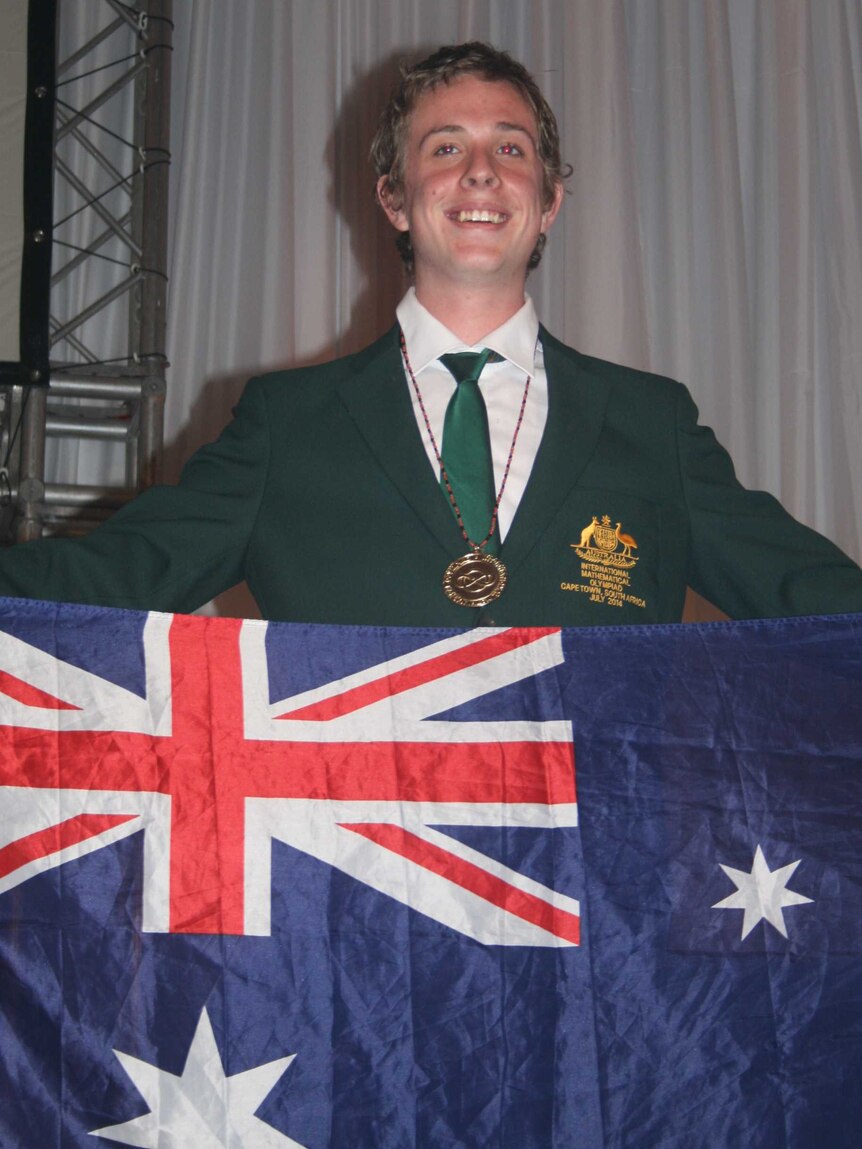 Alex Gunning holding the Australian Flag on stage during his perfect score.