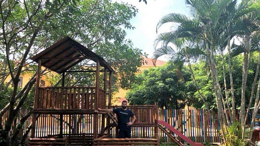SCU student Guy Roberts in the Friendship Village playground, Vietnam