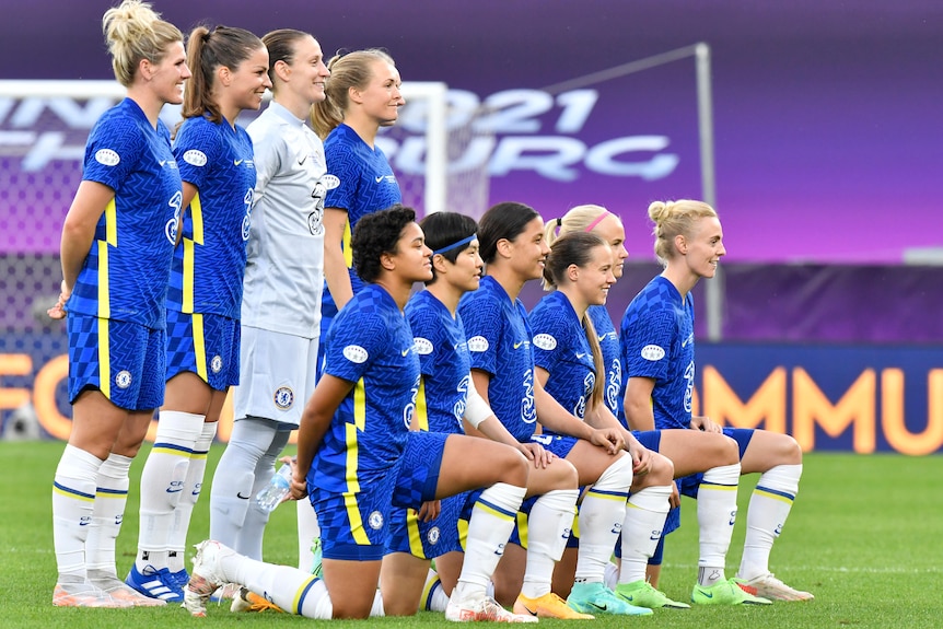 The Chelsea team pose for a photo before the match. Sam Kerr is kneeling and smiling front and centre
