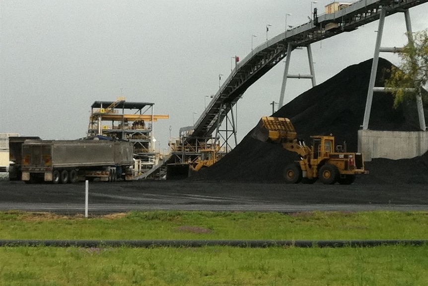 Trucks await to be filled with coal at a mine.