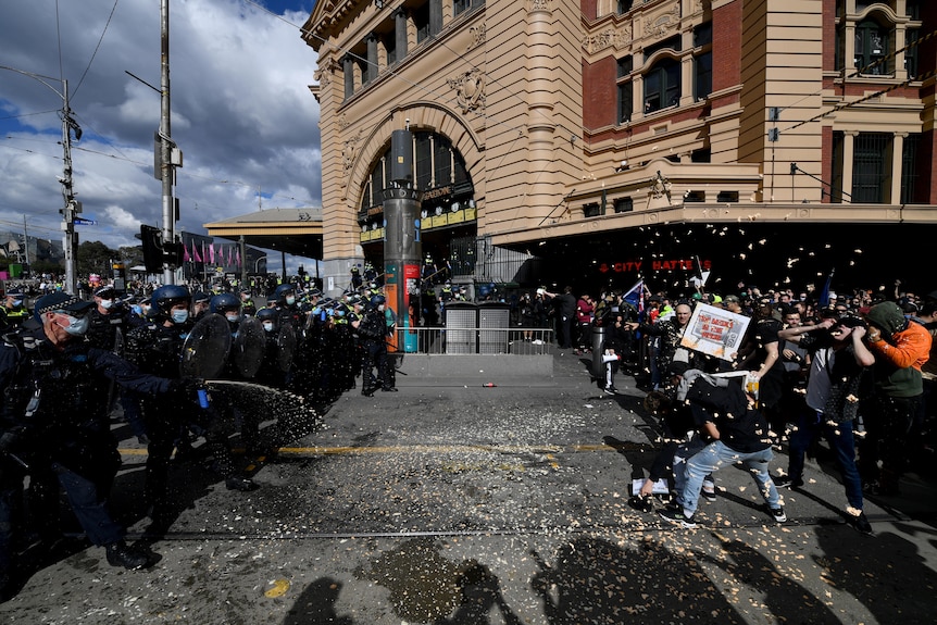 Protesters are pepper sprayed by police during an anti-lockdown protest.