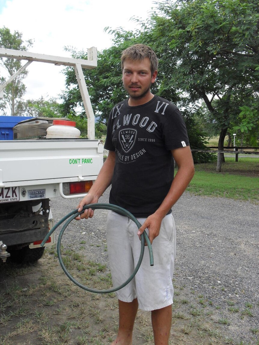 Ben Cook with the hose that saved him