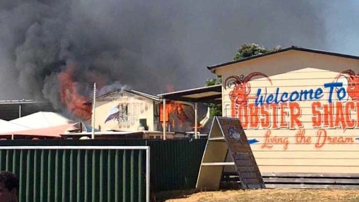 Fire pours from a building at the Lobster Shack restaurant and processing facility in Cervantes.