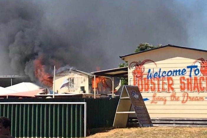 Fire pours from a building at the Lobster Shack restaurant and processing facility in Cervantes.