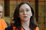 Maria Kavacic wears a high-vis vest at a press conference with Scott Morrison