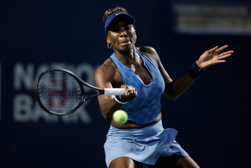 Venus Williams pushes a forehand return back in play during a match.