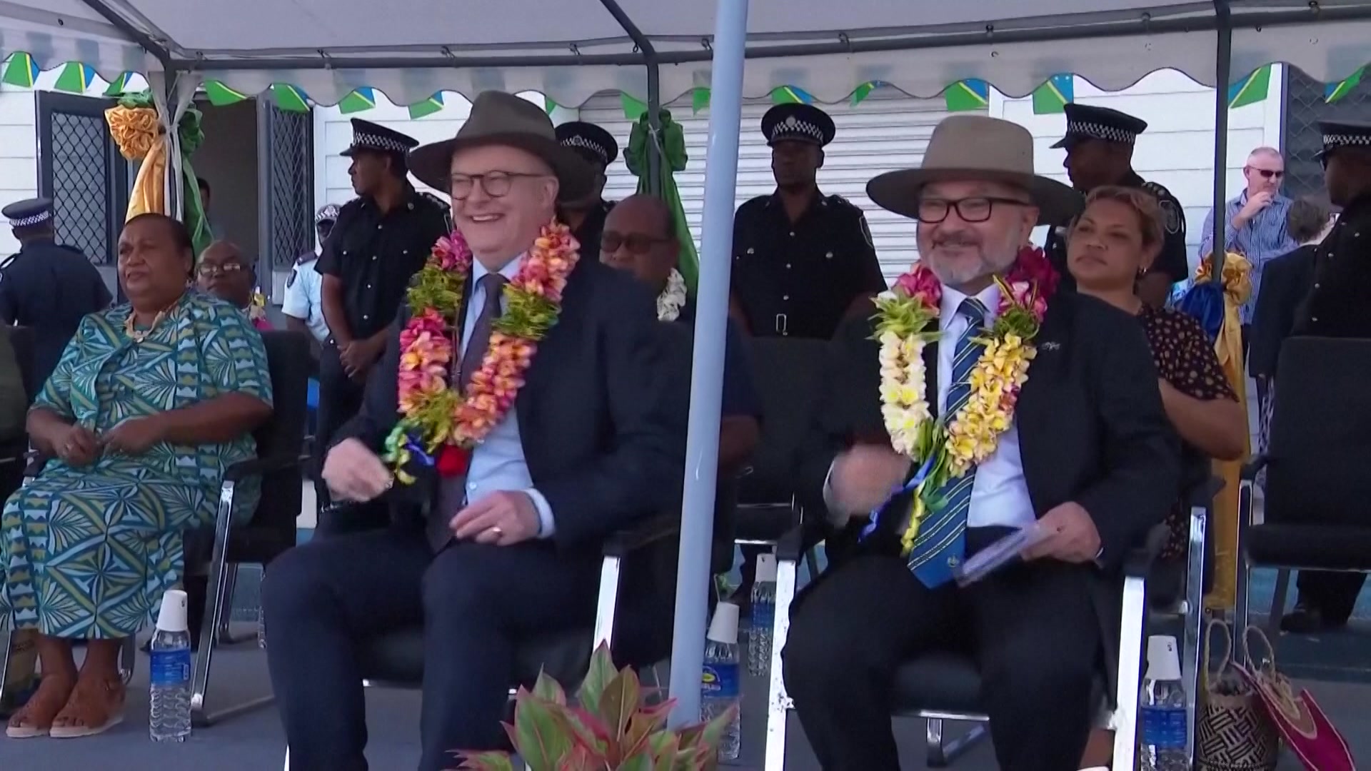 Two men in akubras laughing