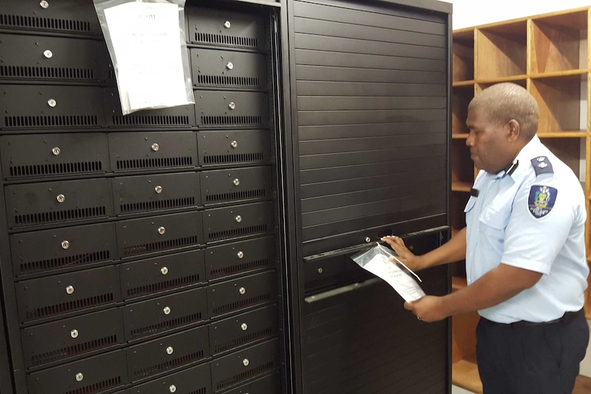 Superintendent Stanley Riolo inspects weapons storage cabinets inside the new armoury