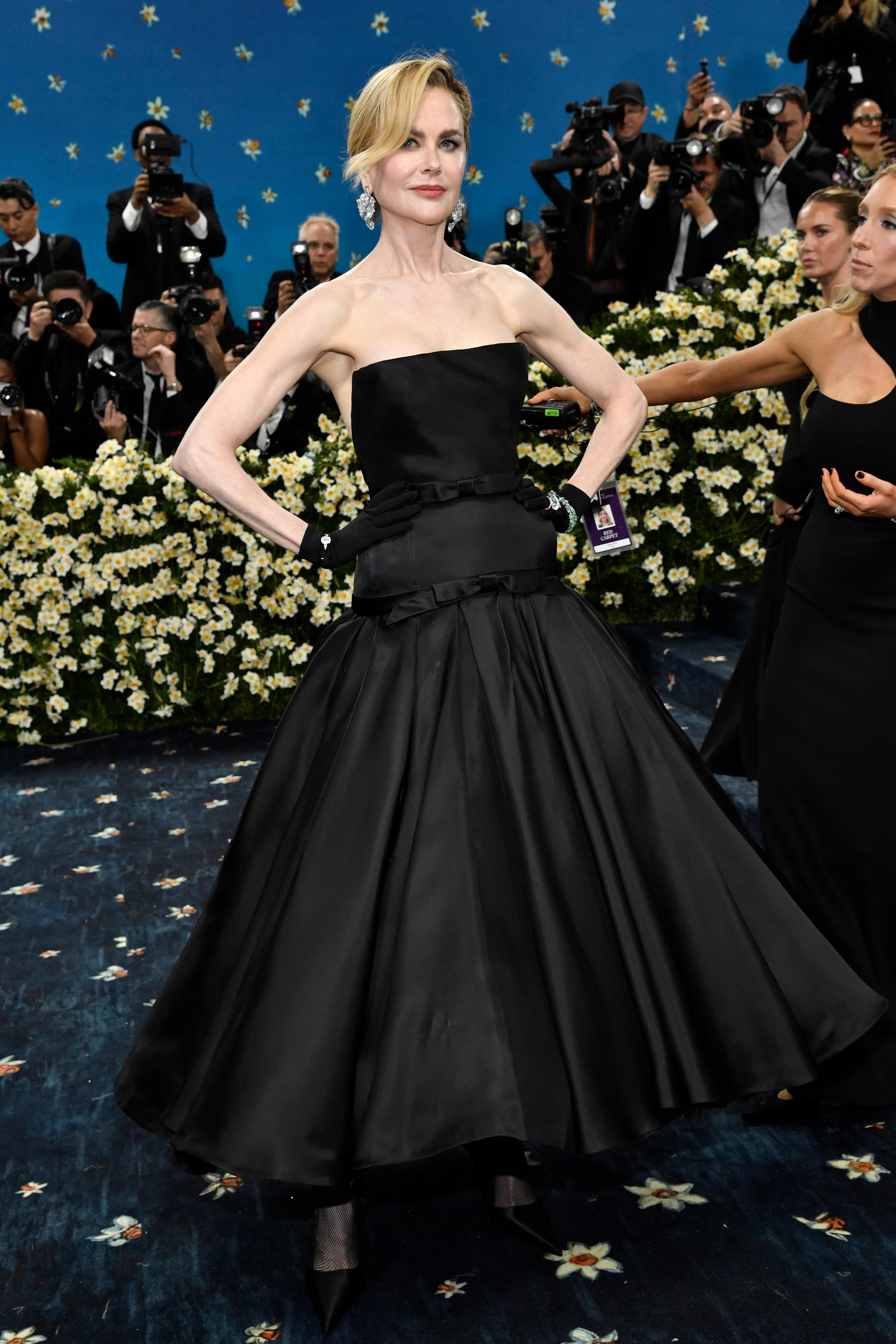 Nicole Kidman wearing a long black strapless gown with a full skirt and black gloves 