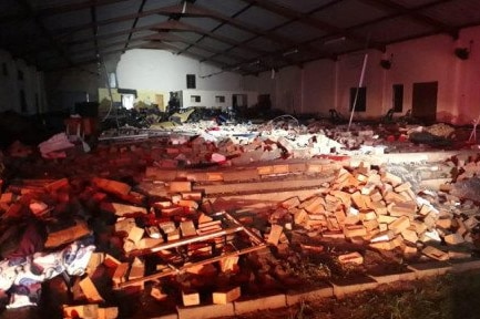 The floor of a church is covered with rubble and debris