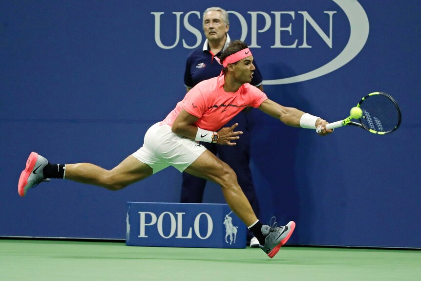 Rafael Nadal stretches for a forehand return on the baseline at the US Open.