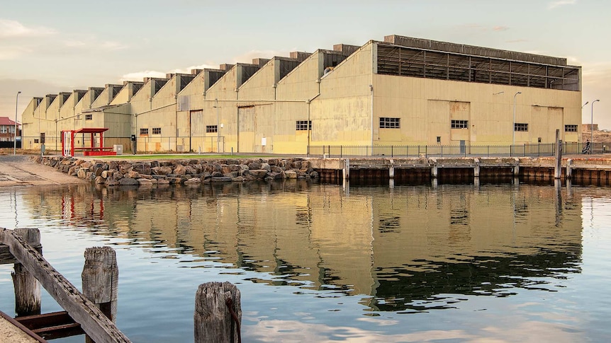 A large building of sheds on the waterfront.