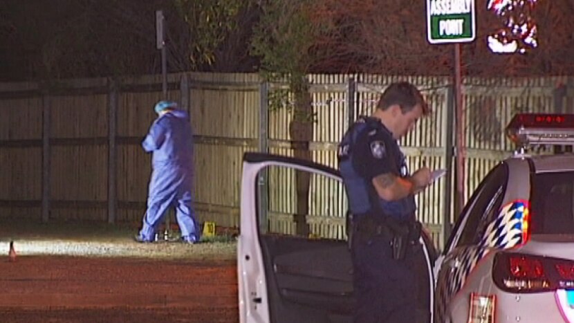 Police officers at the scene of the attack in a Petrie car park