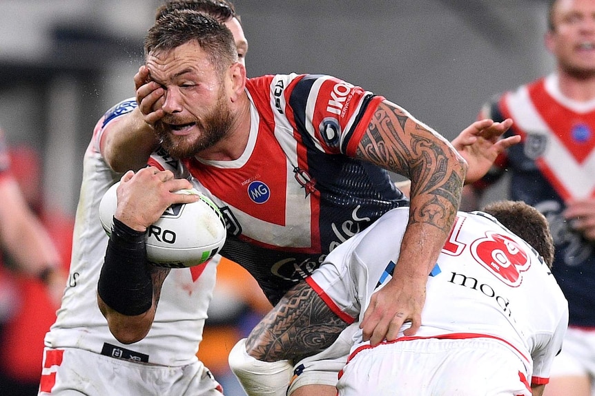 Jared Waerea-Hargreaves is tackled, with a player's hand on his face