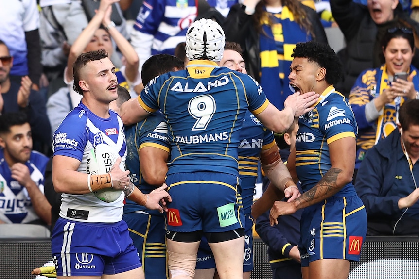 Parramatta Eels players celebrate in front of their fans  after a try against the Canterbury Bulldogs.