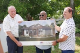 Three men hold a canvas displaying an illustration of their future home which will be purpose built for their needs.
