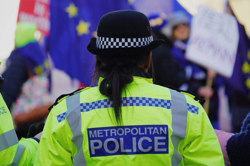 A British police officer wearing a fluoro yellow jacket.