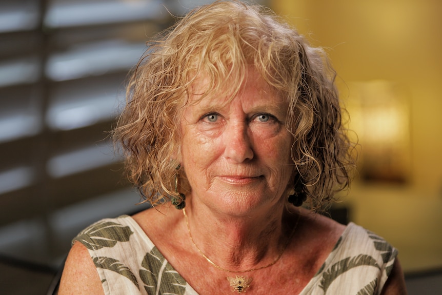 A woman with blonde curly hair.