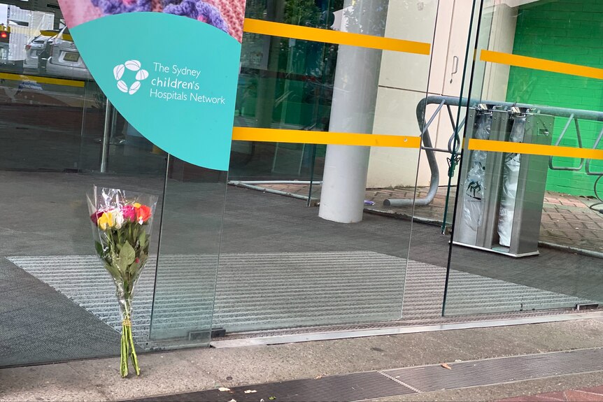 A bouquet of flowers left outside a hospital.