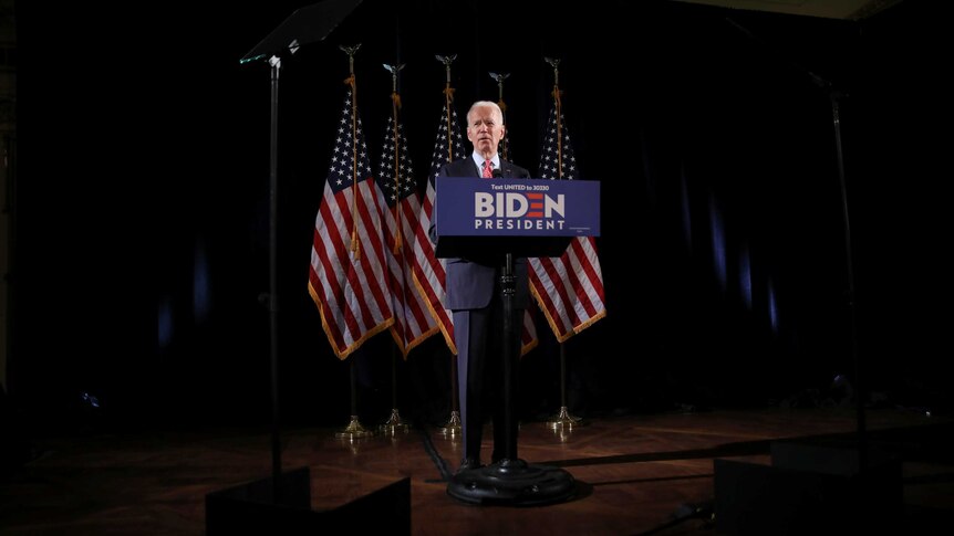 Democratic US presidential candidate and former Vice President Joe Biden speaks behind a podium