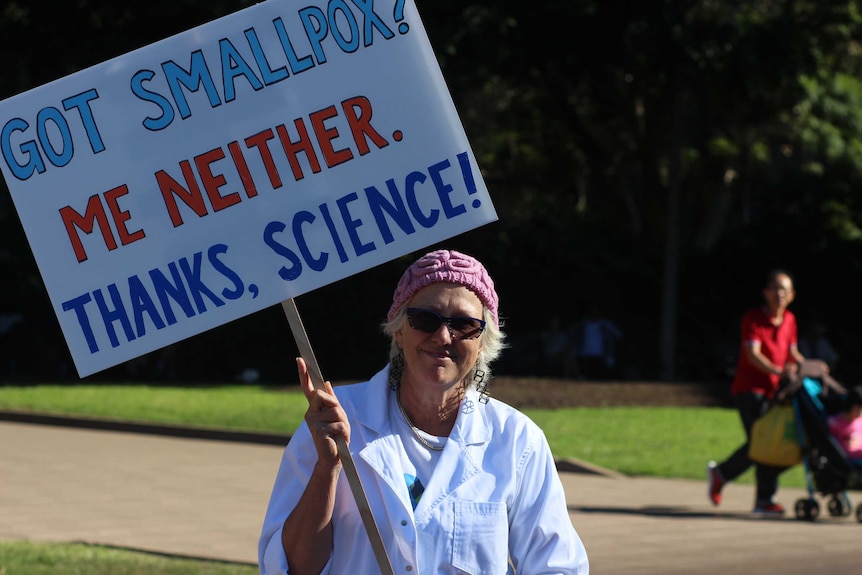 A lady holds a sign reading: "Got smallpox? me neither. Thanks science!" at the march in sydney.
