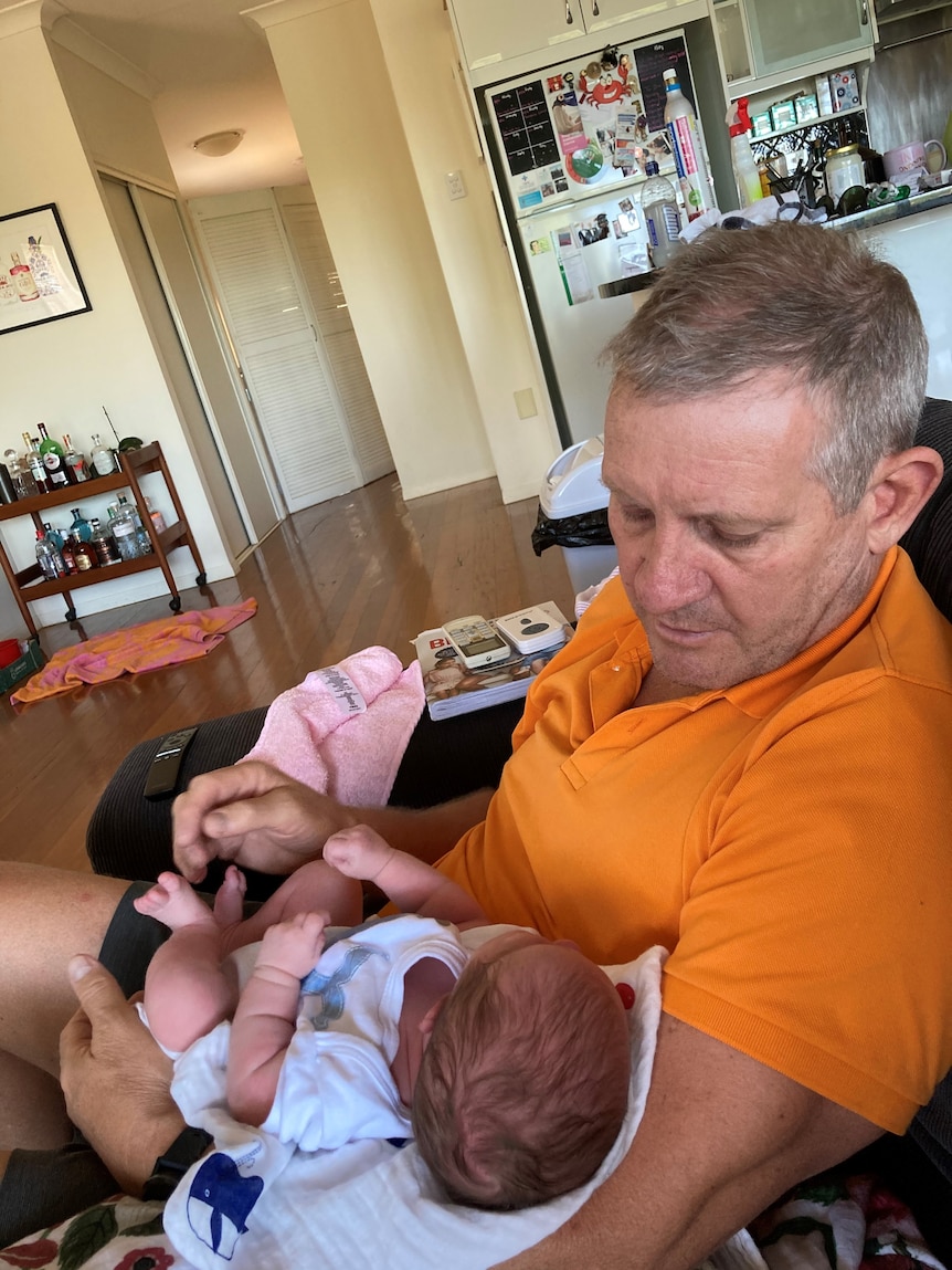 Greg Smith holding his baby granddaughter Margot.