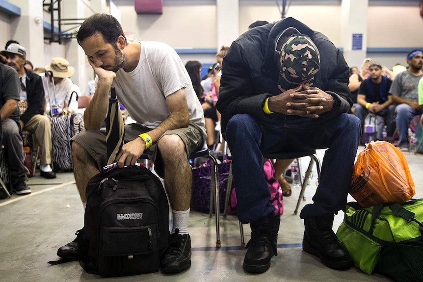Two men rest while waiting in an evacuation centre.