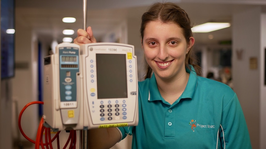 a young woman holding hospital equipment