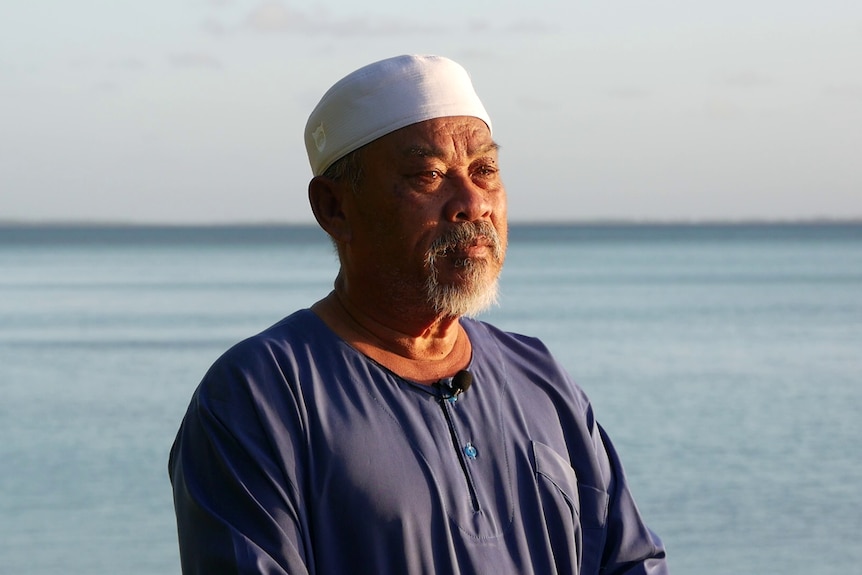 Cocos Island's Imam Haji Adam standing by the water on Home Island