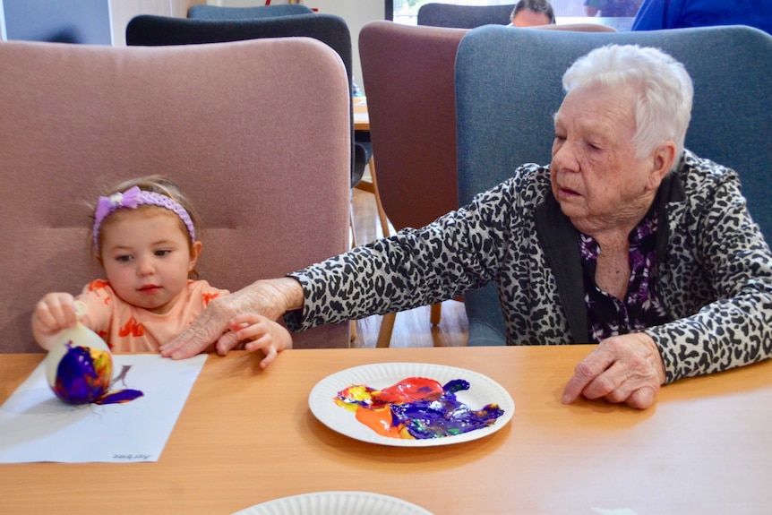 An elderly woman and a child