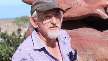 A man in a cap and glasses.