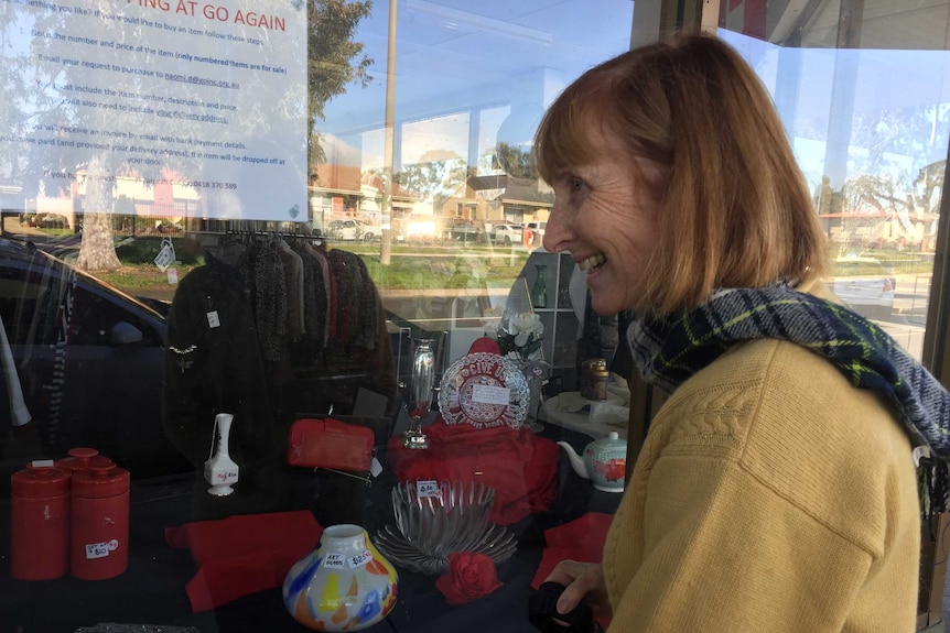 lady looks into shop window