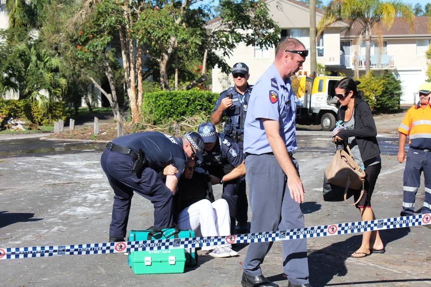 Emergency services help a woman who collapsed.