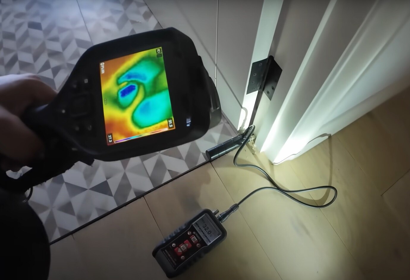 A reader pointed at the floor with colors on it, next to a machine plugged into door jamb