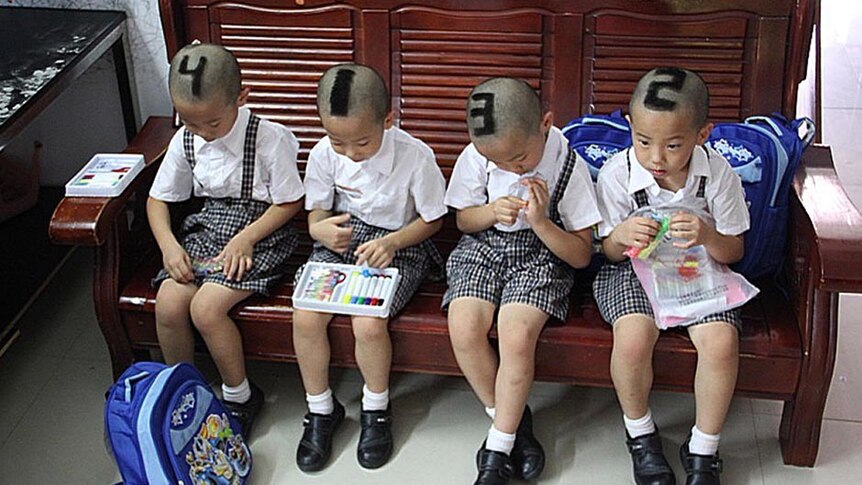 Quadruplets from Shenzhen show off their shaved heads.