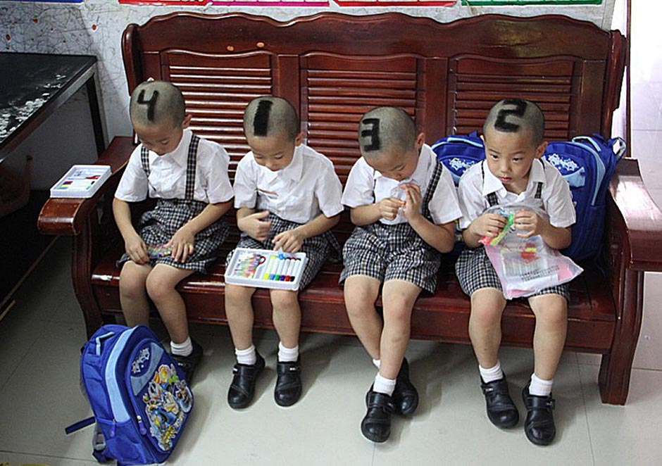 Quadruplets from Shenzhen show off their shaved heads.