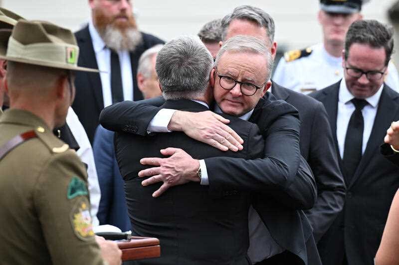 Anthony ALbanese hugs another man
