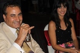 Hazem Hamouda, left, and Lamisse sit at a table at a function in Cairo. They are both smiling at the camera.